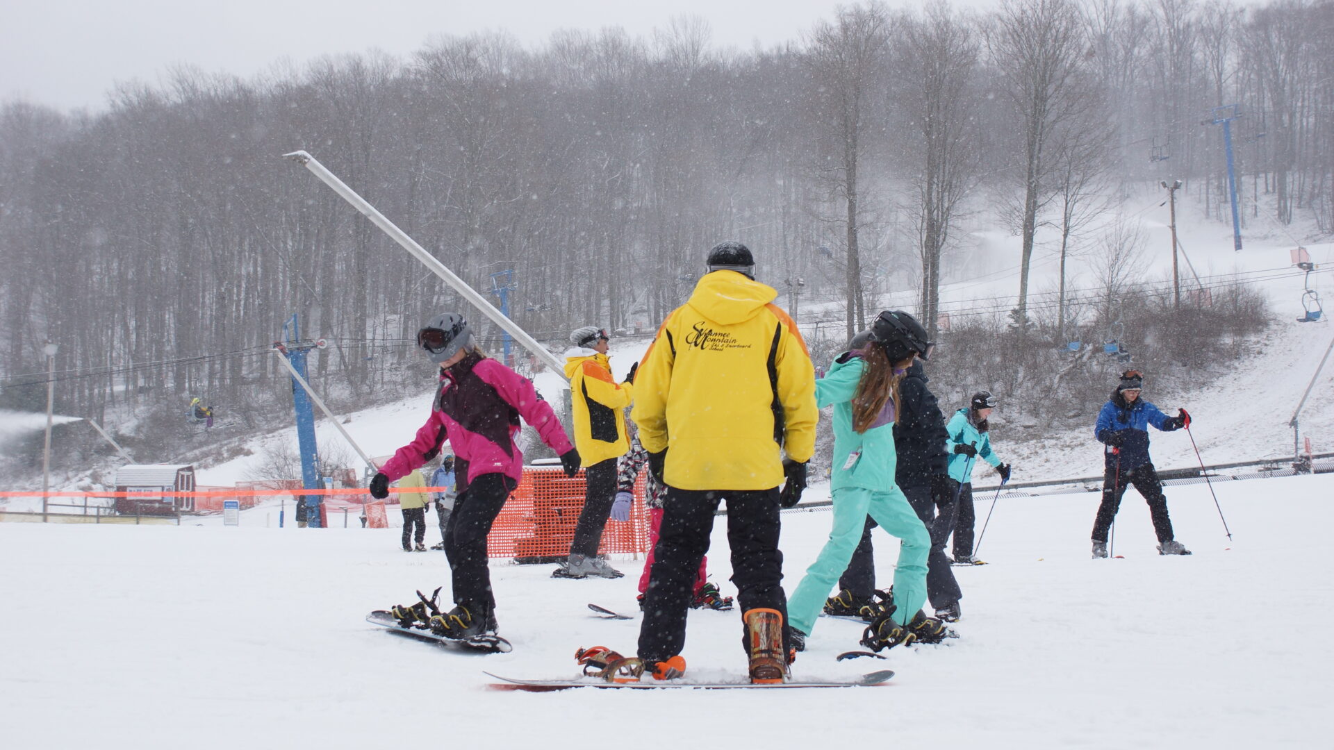 Ski School Children's Program photo demonstrating a snowboarding lesson