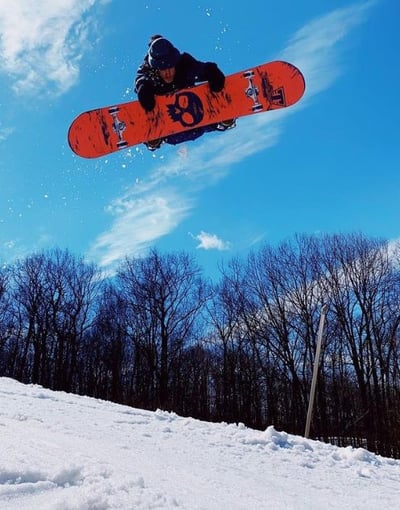 Snowboarder jumping off into the air.